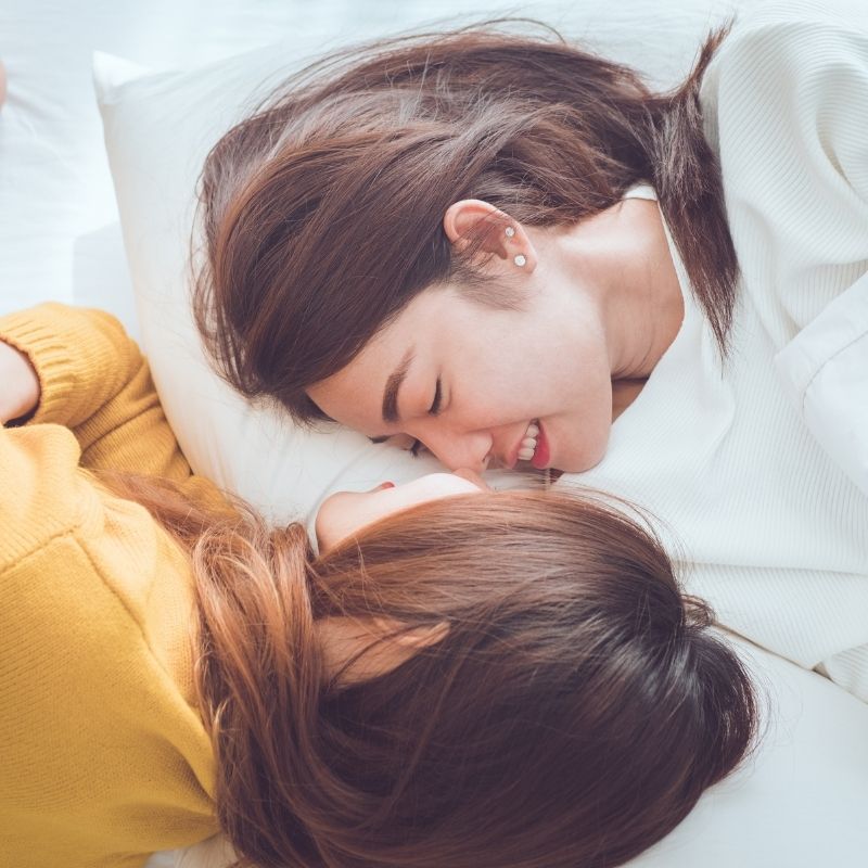 Two people lying close together after participating in sex therapy together.